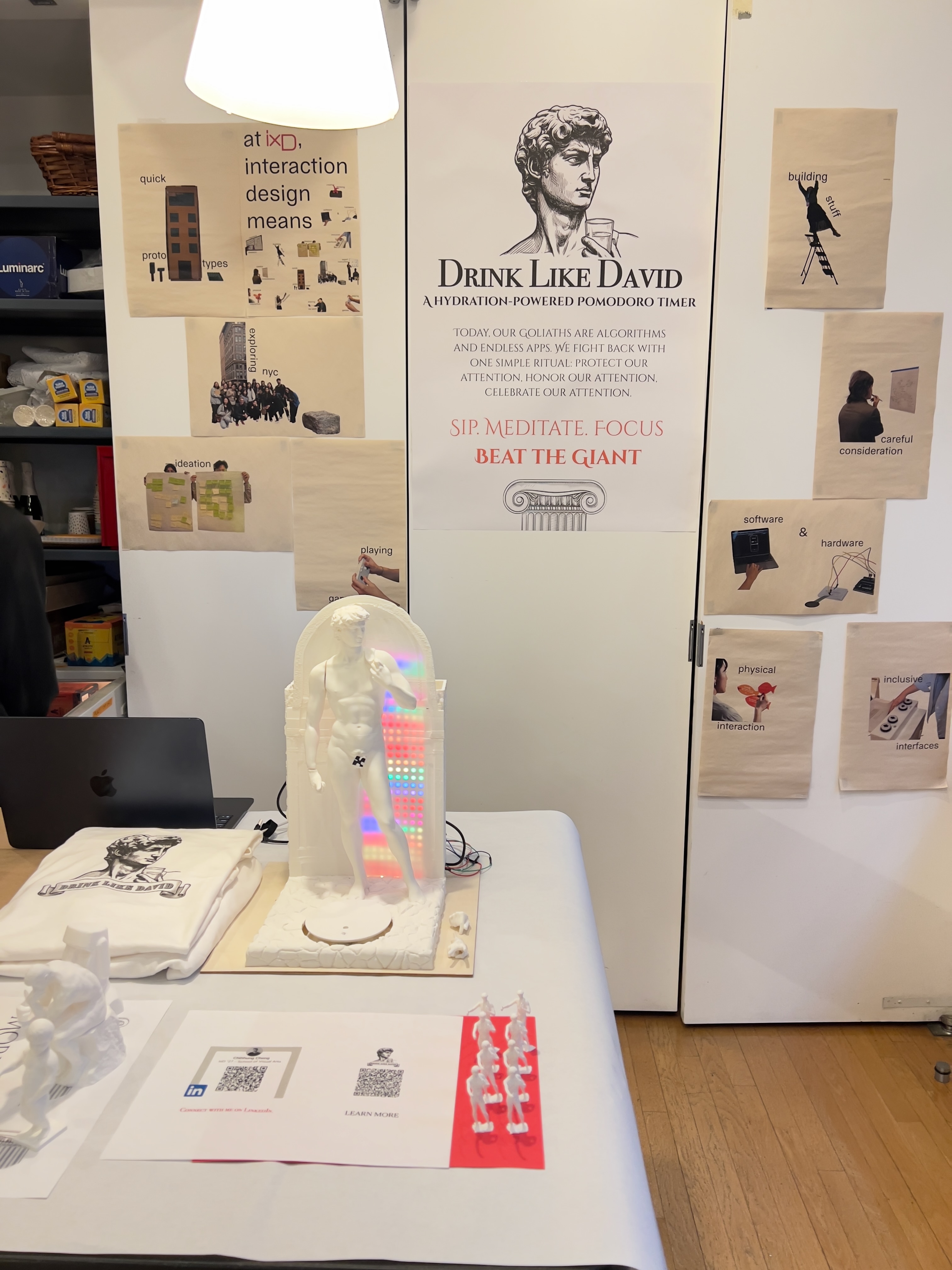 Drink Like David exhibition booth — 3D-printed David with LED, poster, and merch